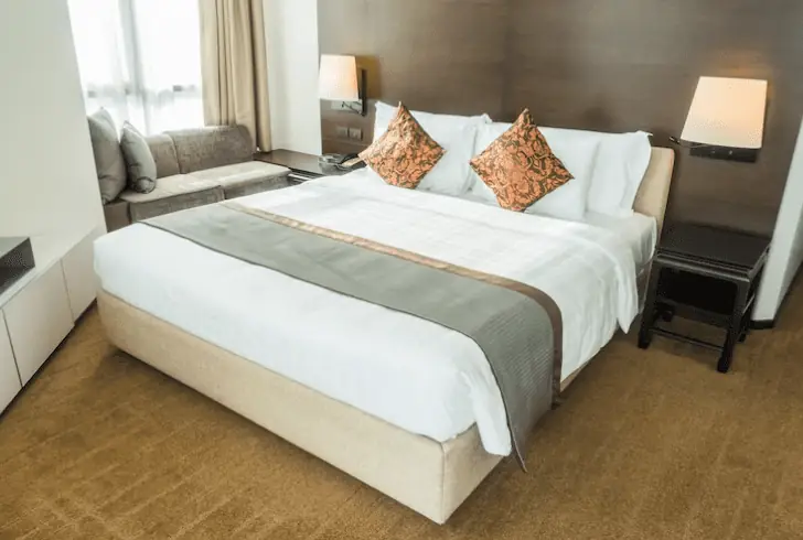 how to make a bed look luxurious - Layering